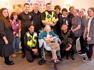 Lillian Hollinshead will celebrate her 102nd birthday at Dovedale Court Care Home, Wednesbury on Monday. She is pictured with staff members, and visiting police and firefighters who dropped in to wish her well before the weekend