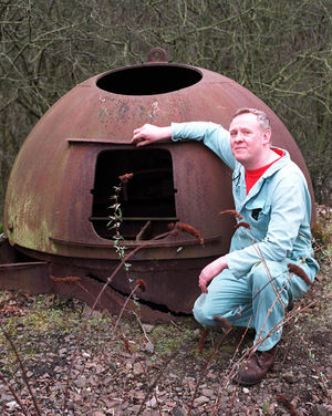 Wartime steel machine gun turret, at Ironbridge Power Station, alongside the railway line next to the Albert Edward Bridge. Pictured on February 7, 2000. Only one left in Shropshire. Pictured is John Firmstone, who was environment auxiliary plant attendant at the power station.