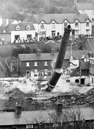 A former factory chimney in Bridgnorth is blown up on Wednesday, December 16, 1987. It was the 100ft high chimney of the former Tatung factory, previously Decca. The old chimney had been a town landmark. It was blown up by Irene Allport who won a had won a competition run by Bridgnorth Rotary Club. She flicked the switch. 