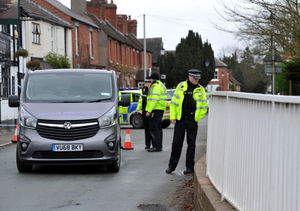 Police and a private ambulance on the bridge over the canal