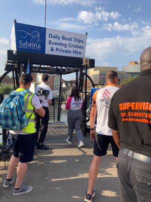 The baton is carried on board The Sabrina on its way to Pengwern Boathouse where was being rowed across the Severn and delivered to the Quarry. Photo: Shropshire Council.