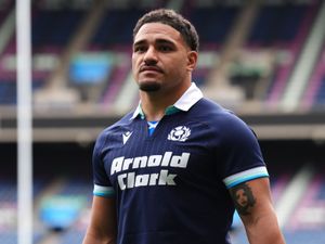 Scotland’s Sione Tuipulotu poses with ball at a team run