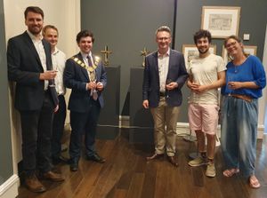 Byrga Geniht and Jacob Chandler showing Alex Wagner, Mayor of Shrewsbury "IN HOC SIGNO" at the Shrewsbury Arts Trail