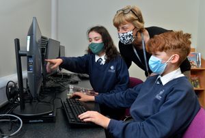 SOUTH COPYRIGHT SHROPSHIRE STAR STEVE LEATH 13/01/2022..Pic at Ludlow C E School for a saturday feature. Pupils in masks and in some cases coats as leaving the windows in the classroom leaves it cold. Headteacher: Paula Hearle with pupils: Flynn Neath 11 and Anya Twiddy 11..
