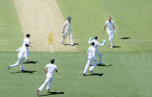 England's Stuart Broad (right) celebrates taking the wicket of Australia's Chris Rogers (centre)