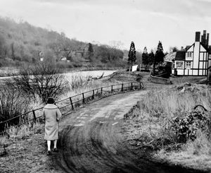 January 11, 1960 – A note on the back reads: ‘Parts of Jackfield, a village on the banks of the River Severn, are gradually slipping into the river. This road, built to replace the one already lost, is crumbling, and Wenlock Borough Council are unable to give it a permanent surface.’
