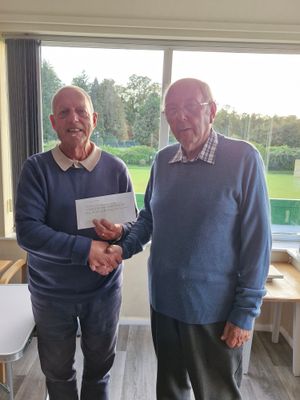 For a good cause – Rich Jones present a cheque for £200 to the Alzheimer's Society to (right) Graham Hughes
