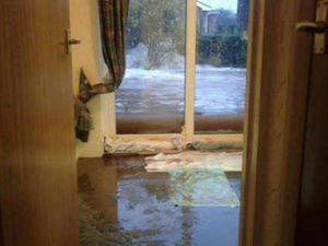 Supporting image for story: Families hit by flood try to salvage homes