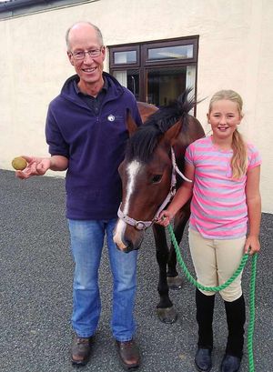 Jim Tipp, holding the bladder stone, with Emma Johnson and Billy