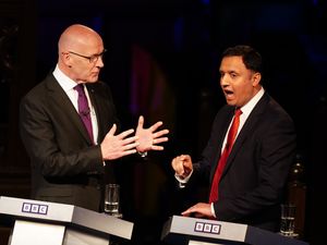 John Swinney and Anas Sarwar interacting, with both gesturing with their hands, during a debate