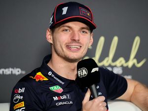 Max Verstappen talks into a microphone during a press conference
