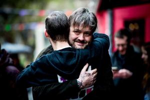 Paul Henshaw celebrates finishing 24 gigs in 24 hours by hugging Dave Burrows