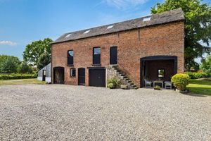 The red brick barn that the listing says has potential for conversion. Picture: Rightmove/Peter James Property Ltd.