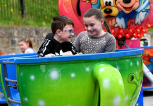 Logan Bebb, six, and Lexi Bayham, 10, have fun on the teacups