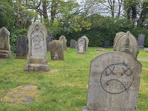 Supporting image for story: Vandalised church hides graffiti with plants to host wedding