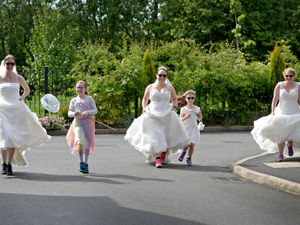 Supporting image for story: Friends parade the streets in wedding dresses to raise cash for air ambulance charity