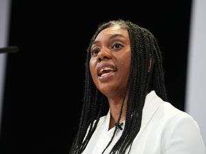 Headshot of Kemi Badenoch speaking into a mic