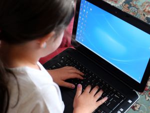A child using a laptop computer