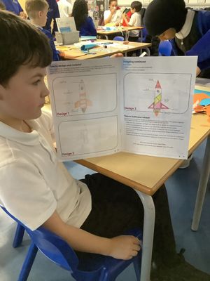 A Lift Four Dwellings Primary pupil shows off his rocket design