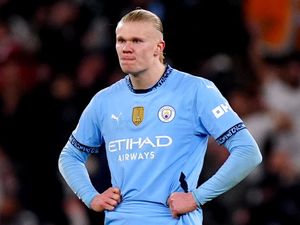 Erling Haaland stands with hands on hips