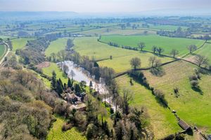 The cottage boasts expansive grounds and a large private lake. Picture: Miller Evans/Rightmove.