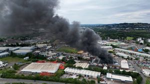 Black smoke pours into the sky from the fire at GB Tyres in West Bromwich. Photo: Tim Thursfield