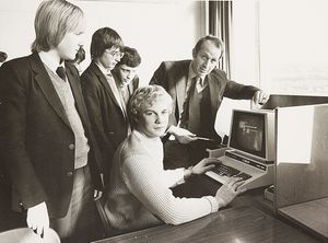 'You're never too old to learn goes the saying. And that is true in the case of 20-eyar-old John Davies, who has gone back to school... He was one of the first people to take up the opportunity offered by the Hillcrest School/Community College, Simms Lane, Netherton, to encourage adults to make use of education facilities. John felt he would benefit from the return to the school desk  to take a basic computer course.' The photograph shows John at the computer with Gerrard Oldham and school pupils, in January 1983.