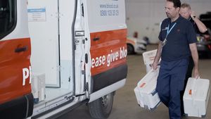 Drivers loading blood van