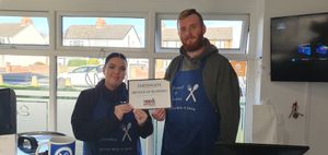 Kimberley Shaw and Adam Slater show off the certificate for being named a readers favourite