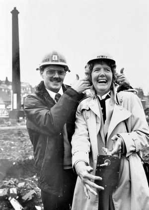 A former factory chimney in Bridgnorth is blown up on December 16, 1987. The caption reads: 'All set to blow. Demolition expert Richard Fowler with Mrs Irene Allport.' The chimney was blown up by Irene Allport of Stourbridge who had won a competition to flick the switch run by Bridgnorth Rotary Club. 