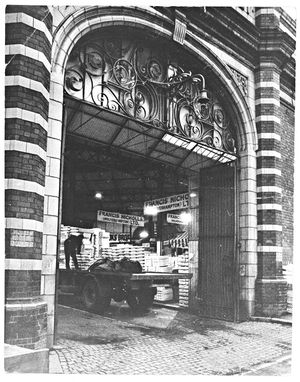 Wholesale Market, Wulfruna Street, Wolverhampton. This photograph taken in April 1970, is looking in through the market hall entrance with a good view of the decorated wrought iron gates. Francis Nicholls Ltd. signs are clearly visible, with stacked up produce and the rear of a trailer.