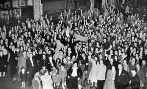 It's 1am on August 15, 1945, outside the American Red Cross Club, where jubilant Shrewsbury crowds lit a fire in the street.