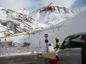 An emergency helicopter flying over the ski lifts at the Astum ski resort