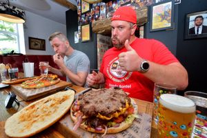 Randy Santel and Max Stanford taking on the Houston Heart Stopper burger.