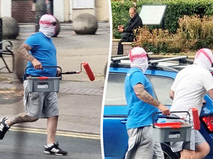 Supporting image for story: Men in St George's masks pictured painting England flags on roundabouts and crossings in Walsall