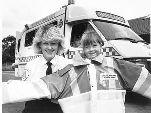 Lunt Community Centre in Bilston, 1993: Children on the centre's holiday play scheme were given a day's lesson in how to look after themselves by ambulance and fire officers. The photograph shows Natalie Bettles trying on a ambulance jacket, with Adele Stokes of the Staffordshire Ambulance Service.