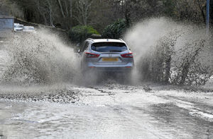 Vehicles push through floodwater on the A41 near Tettenhall. Photo: Tim Thursfield