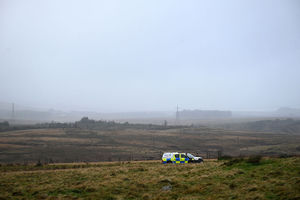 A police car is pictured near to where an Avanti West Coast train, travelling from Glasgow to London Euston sation, derailed, near Shap, north west England on November 3, 2025.