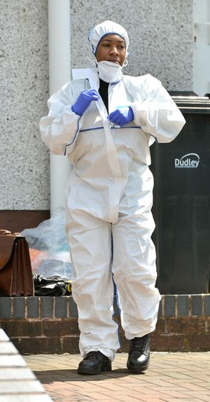 An officer in a forensic suit