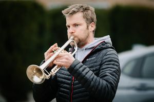 A trumpeter plays to mark Lina's birthday