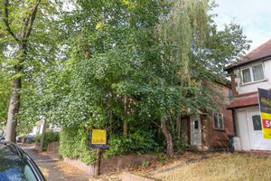 The house hidden behind foliage on Mavis Road in Longbridge, Birmingham. 