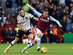 Aston Villa's Emiliano Buendia and Manchester United's Diogo Dalot