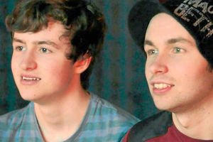 Sam and Scott Piggott watch home movies in a scene from the film