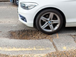 A car about to drive into a large pothole