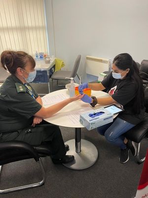 Integrated emergency and urgent care tutor Mandy Jones gets a finger prick test from Priya from NHS Blood and Transplant