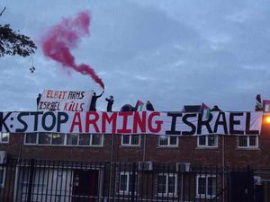 Supporting image for story: Anti war protesters on roof of factory they claim is 'supplying weapons to Israel'
