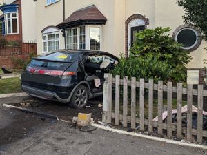 Supporting image for story: Unconscious driver cut out of car after crashing into house