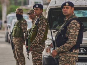 Indian paramilitary soldiers stands guard at a temporary check point on a road leading to the airport after loud explosions were heard in Srinagar, in Indian controlled Kashmir
