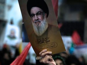 A photo of Hassan Nasrallah is held up