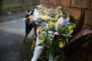 Tributes have been left outside the house on Elm Road